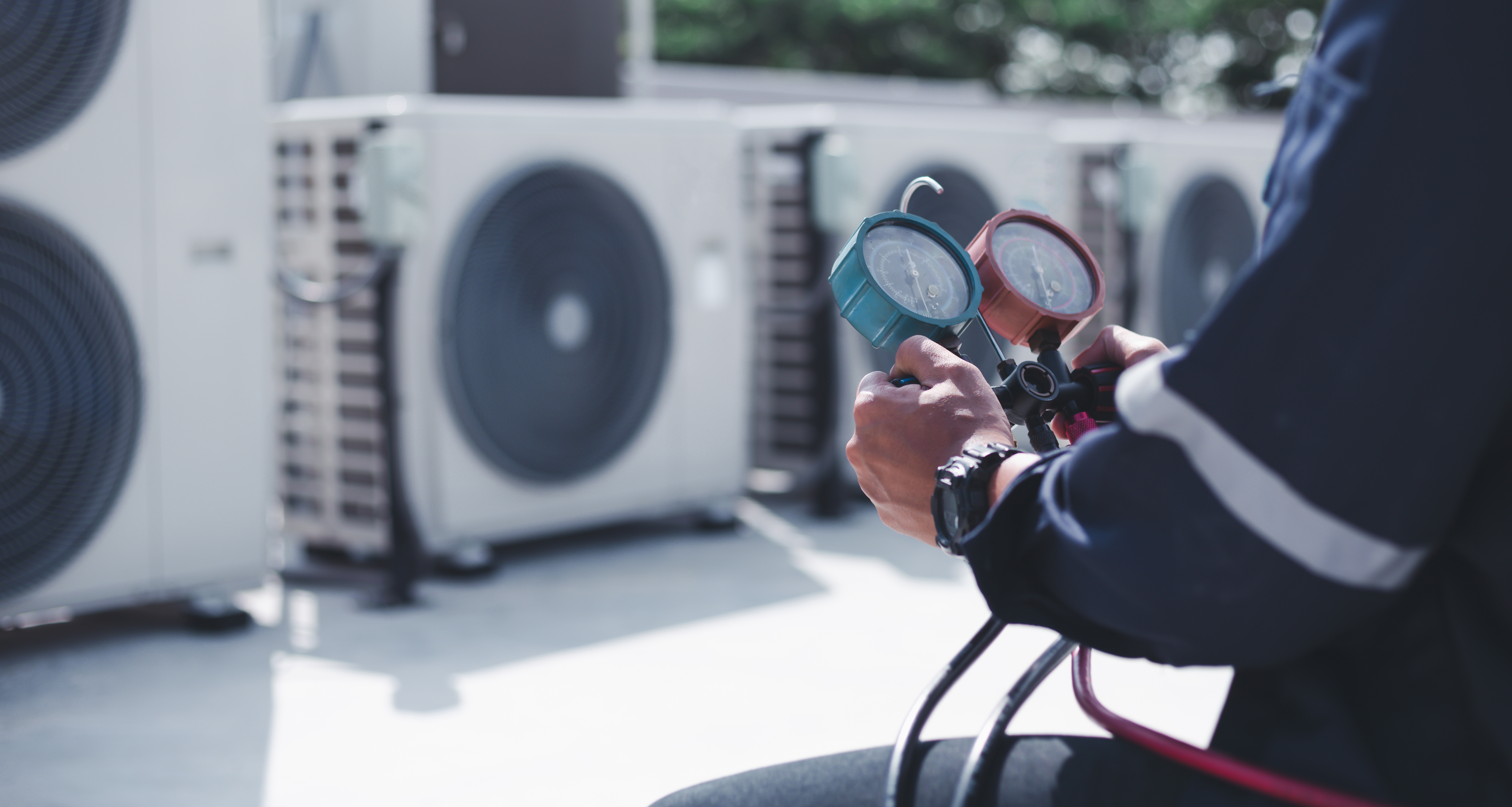 Technician is checking air conditioner ,measuring equipment for